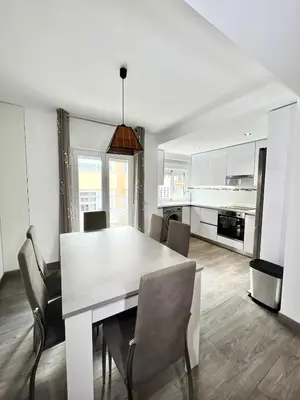a kitchen and dining room with a white table and chairs at Cullera Sea and Mountain Balcony in Cullera