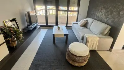 a living room with a couch and a coffee table at Apartment 300 m from the beach ,parking , breakfast in Valencia