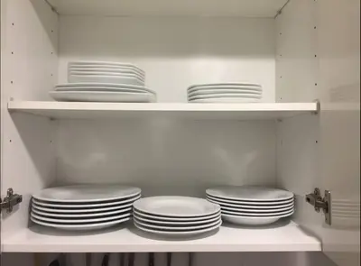 a bunch of plates on shelves in a kitchen at Apartment 300 m from the beach ,parking , breakfast in Valencia