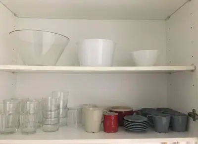 a shelf with bowls and other glass items on it at Apartment 300 m from the beach ,parking , breakfast in Valencia