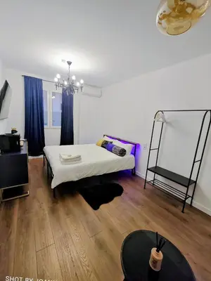 a white room with a bed and a table at Royal Lux in Sagunto