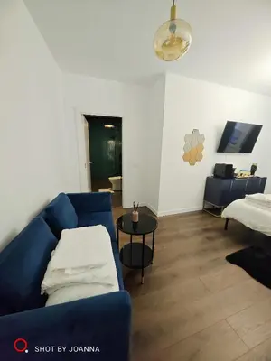 a living room with a blue couch and a table at Royal Lux in Sagunto