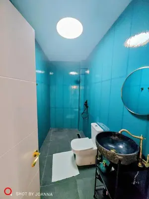 a blue bathroom with a sink and a toilet at Royal Lux in Sagunto