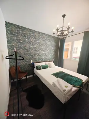 a bedroom with a bed with a green accent wall at Royal Lux in Sagunto