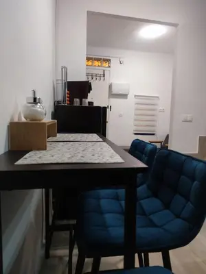 a dining room with a table and blue chairs at La Casita de Cullera in Cullera