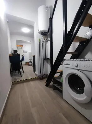a laundry room with a washer and a staircase at La Casita de Cullera in Cullera
