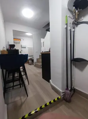 a room with a broom and stools in a room at La Casita de Cullera in Cullera