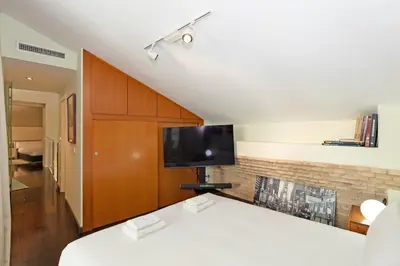a bedroom with a bed and a tv on a wall at GuestReady - Charming place in Valencia in Valencia