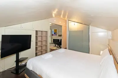 a bedroom with a bed and a flat screen tv at GuestReady - Charming place in Valencia in Valencia