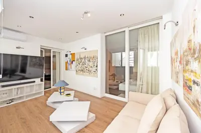 a living room with a white couch and a tv at GuestReady - Charming place in Valencia in Valencia