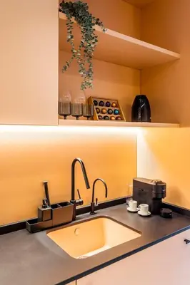 a kitchen counter with a sink and a coffee maker at Lujoso apartamento en Ruzafa in Valencia