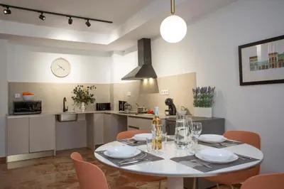 a kitchen and dining room with a table and chairs at SingularStays Palau de la Musica Lofts in Valencia