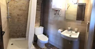 a bathroom with a toilet and a sink at Penthouse with two terraces near the sea in Valencia