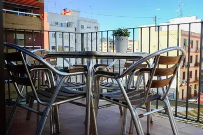 a table and chairs sitting on top of a balcony at Beautiful penthouse with two terraces near the sea in Valencia