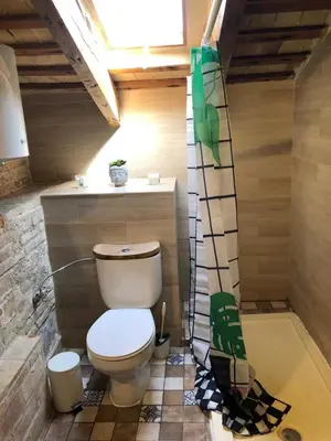a bathroom with a toilet in a small room at Beautiful penthouse with two terraces near the sea in Valencia