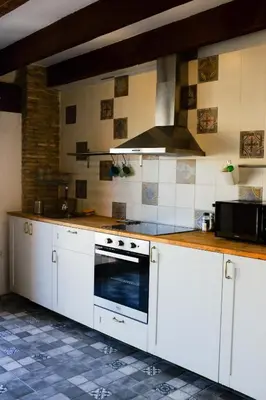 a kitchen with white cabinets and a stove top oven at Beautiful penthouse with two terraces near the sea in Valencia