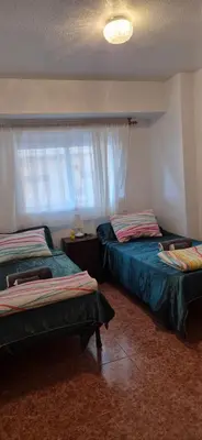 a bedroom with two beds and a window at A fantastic apartment on the beach in Canet de Berenguer