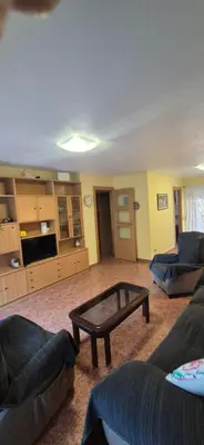 a living room with a couch and a coffee table at A fantastic apartment on the beach in Canet de Berenguer