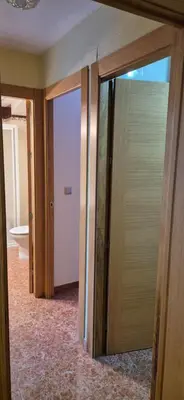 a hallway with two sliding glass doors in a room at A fantastic apartment on the beach in Canet de Berenguer