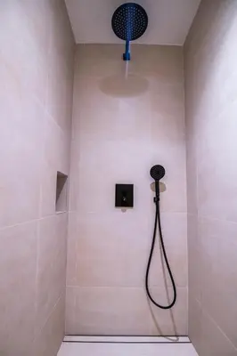 a bathroom with a shower with a shower head at Apartamento moderno con terraza en el centro in Valencia