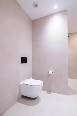 a white bathroom with a toilet in a room at Apartamento moderno con terraza en el centro in Valencia