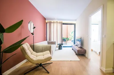 a living room with a couch and a chair at Apartamento moderno con terraza en el centro in Valencia