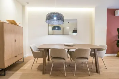 a dining room with a wooden table and chairs at Apartamento moderno con terraza en el centro in Valencia