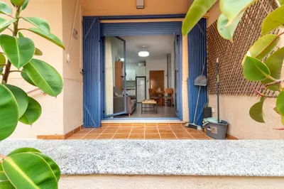 an entrance to a house with a blue door at Global Vacacional, Planta baja en Canet de Berenguer in Canet de Berenguer