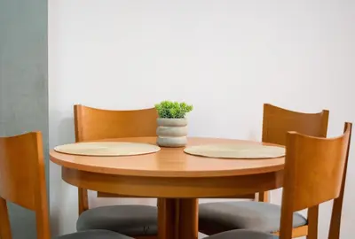 a wooden table with chairs and a potted plant on it at Global Vacacional, Planta baja en Canet de Berenguer in Canet de Berenguer