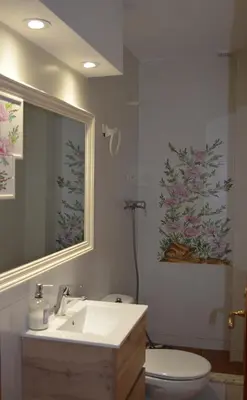 a bathroom with a sink and a toilet and a mirror at Els Vents primera línea playa Puçol in Puzol