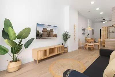 a living room with a couch and a table at Travel Habitat Nou Mestalla Suites in Valencia