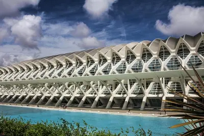 a large building with a white roof and a blue sky at Travel Habitat Nou Mestalla Suites in Valencia