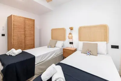 a bedroom with two beds and two tables at Travel Habitat - Apartamento Familiar & Espacioso de 3 Dormitorios in Valencia