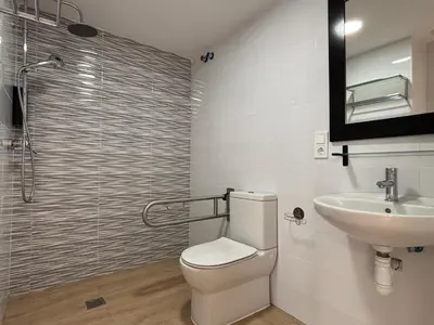 a bathroom with a toilet and a sink and a shower at VMC Rooms in Tavernes de Valldigna