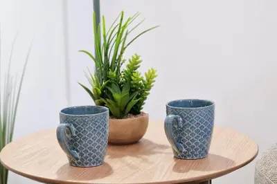 three blue cups sitting on a table with a potted plant at DM1 - Loft Valencia in Valencia