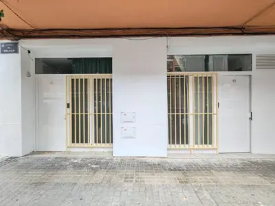 two doors in a white building with a brick floor at DM1 - Loft Valencia in Valencia