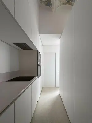 a kitchen with white cabinets and a ceiling at Superloft in Burjasot