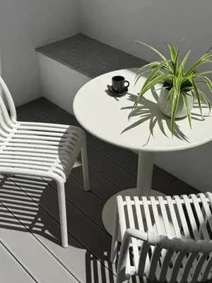 a white table and two chairs and a plant at Superloft in Burjasot