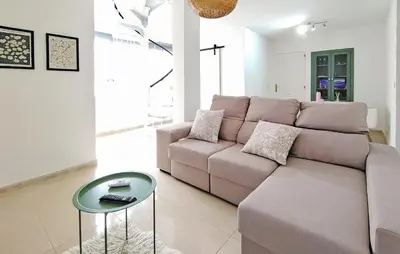 a living room with a couch and a table at Pet Friendly Home In Puerto De Sagunto in Puerto de Sagunto