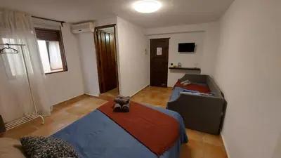 a room with a bed and a couch in it at Las Anas Rural in Cortez de Pallas