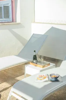 a white table with a bottle of wine on it at Valencia Beach Luxury Penthouse, Late Checkout in Valencia