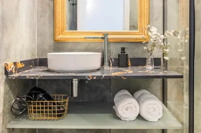 a bathroom with a shelf with towels and a mirror at Valencia Beach Luxury Penthouse, Late Checkout in Valencia