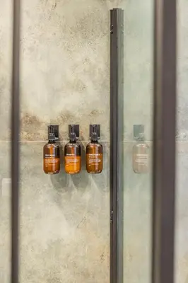 a group of four bottles hanging on a wall at Valencia Beach Luxury Penthouse, Late Checkout in Valencia