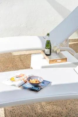 a white table with a bottle of wine and glasses at Valencia Beach Luxury Penthouse, Late Checkout in Valencia
