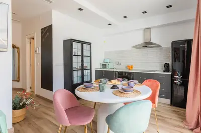 a kitchen with a white table and chairs at Valencia Beach Luxury Penthouse, Late Checkout in Valencia