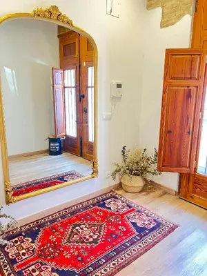 a room with a large mirror and a rug at Luxury apartament, close to Cabañal Beach, Late Checkout in Valencia