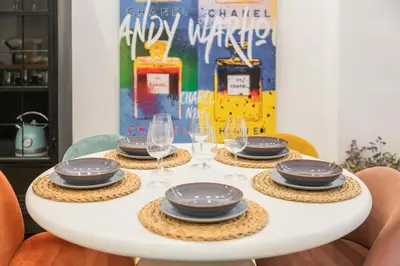 a table with plates and wine glasses on it at Luxury apartament, close to Cabañal Beach, Late Checkout in Valencia
