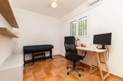 a room with a desk with a computer and a chair at Chalet Barraca d 'Aigües Vives in Barraca de Aguas Vivas