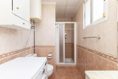 a small bathroom with a toilet and a shower at Chalet Barraca d 'Aigües Vives in Barraca de Aguas Vivas