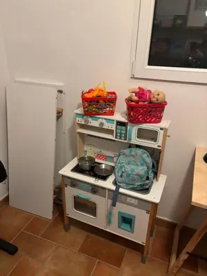 a toy kitchen with a pretend stove and a refrigerator at Chalet Barraca d 'Aigües Vives in Barraca de Aguas Vivas